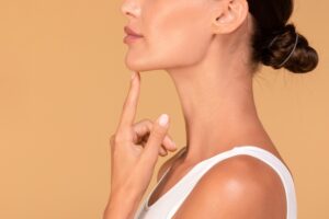 Woman happy with her facial balance after choosing chin filler vs chin implant care