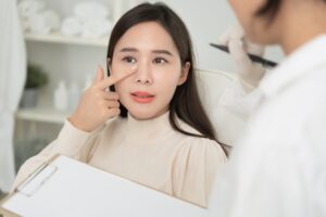 A patient consulting with a surgeon about open rhinoplasty results